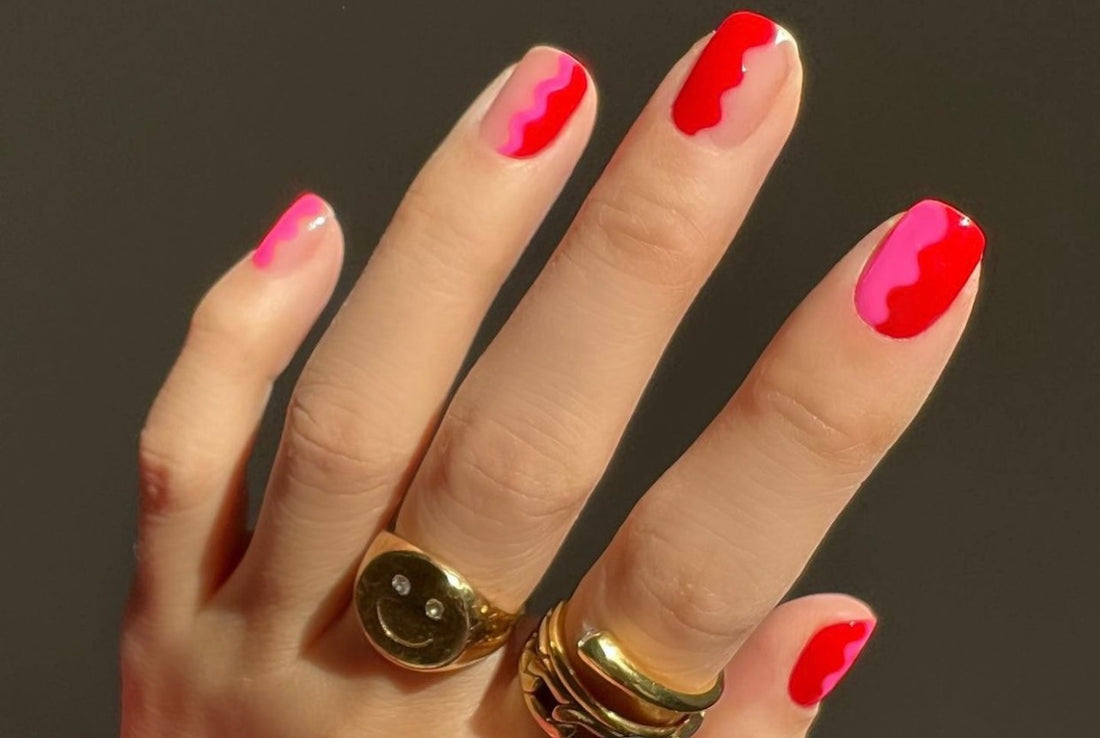 Colorful nail art for Valentine's day, bright neon pink and golden chunky rings